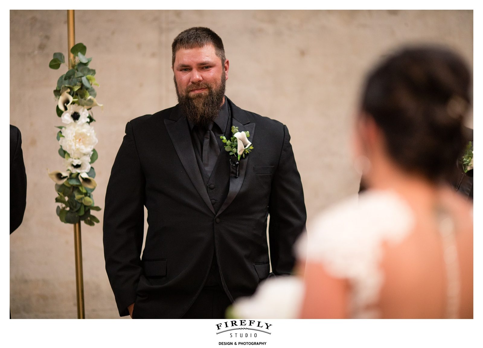 groom watching his bride walk down the aisle